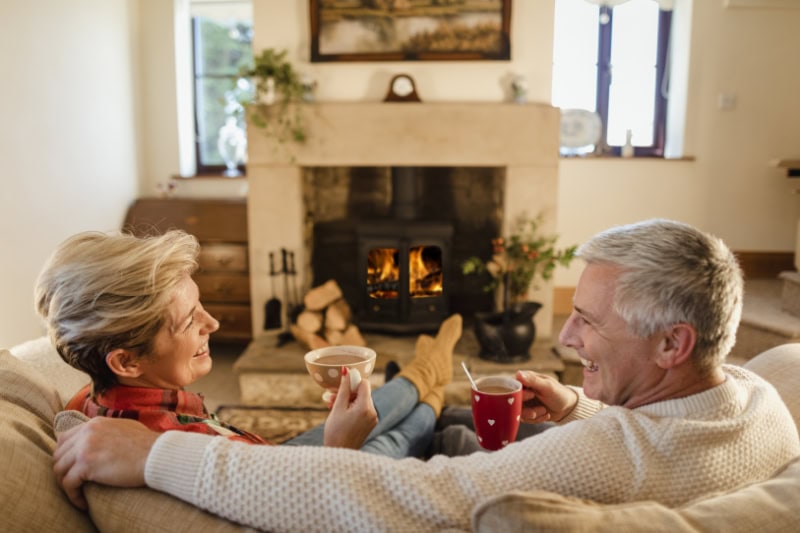 How Do I Keep My Heat During Extreme Cold Weather? Couple on couch.