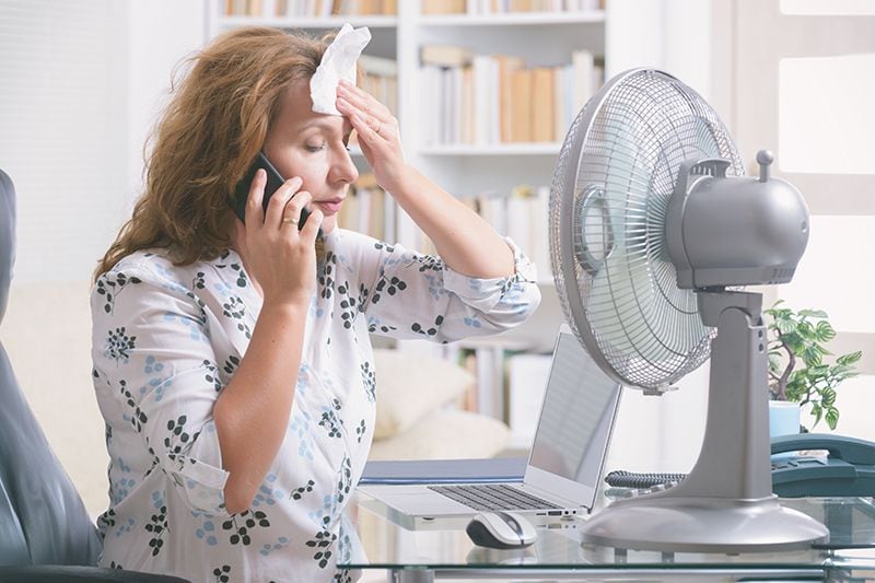 Image of person in front of fan. When Do I Replace My Air Conditioner?