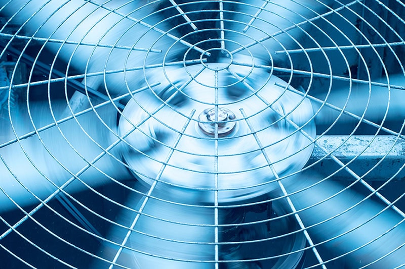 Spring AC Maintenance Tips. Photo of a fan up close from an HVAC