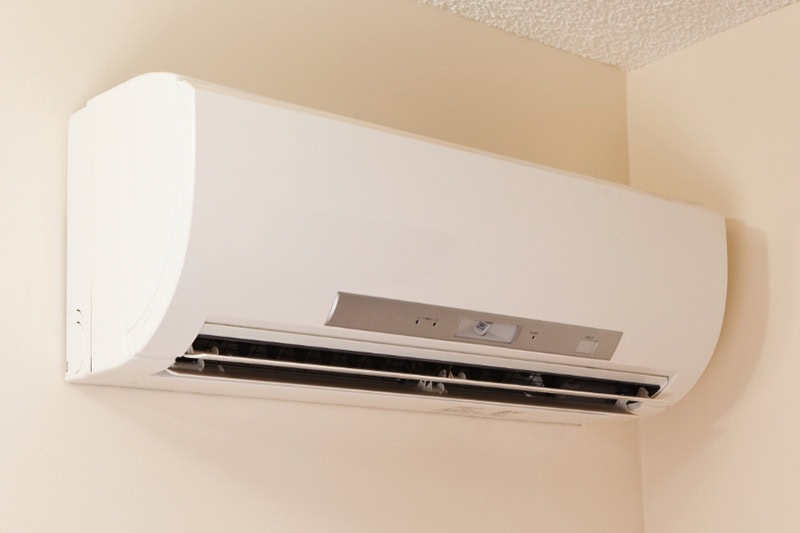 How Much Does it Cost to Install a Ductless Mini Split? A wall-mount mini-split heating and air conditioning unit installed in a new house. A modern heat pump, this unit heats a house in winter and cools in the summer. This type of system eliminates ductwork which is a primary source of inefficiency in a conventional system making this about 30% more efficient. This particular unit has an eye sensor which pans the room looking for hot or cold spots and directs the airflow accordingly.